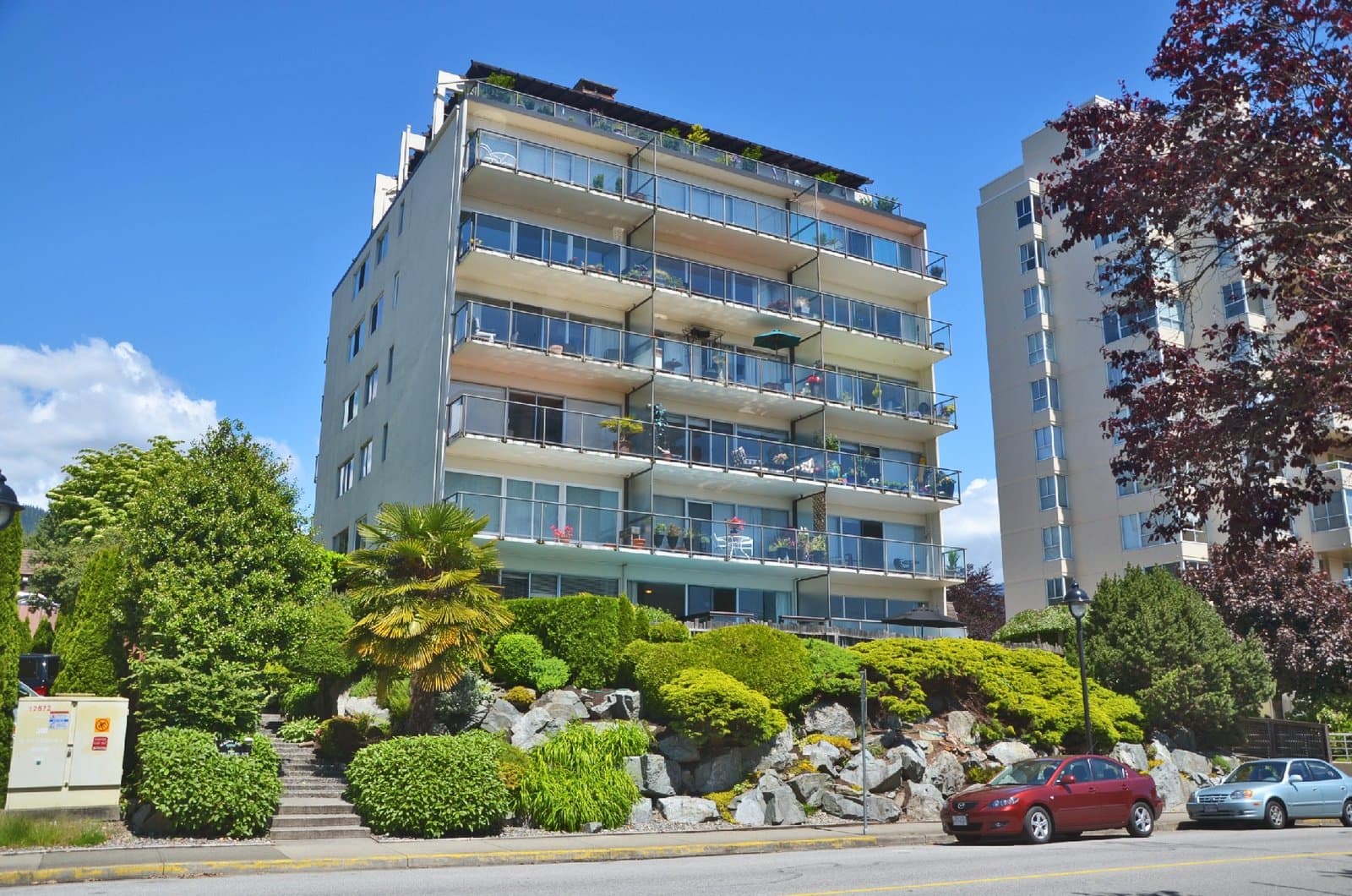 Premium 7-storey concrete residential strata building on Bellevue Avenue in Ambleside, West Vancouver.